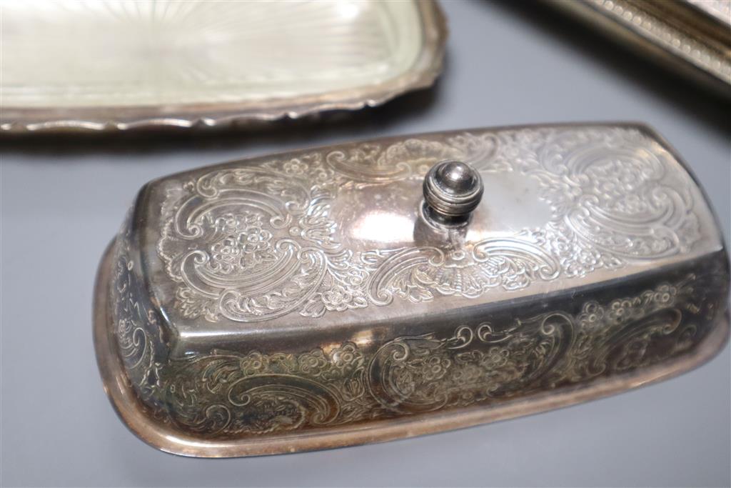 A pair of silver plated entree dishes with covers and handles, a plated butter dish, two condiments, a small vase and a trinket box